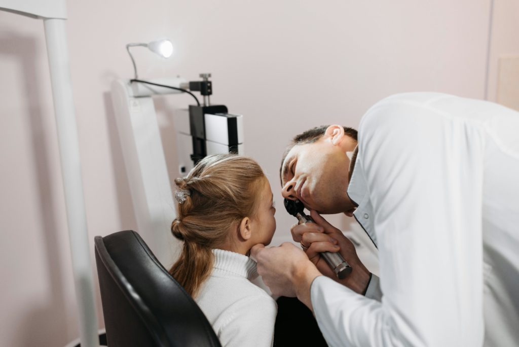 doctor examining patient nose modern interior professional photography.jpg