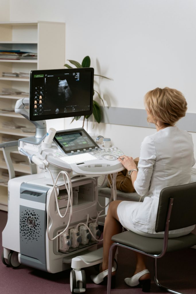 professional cardiologist performing heart ultrasound modern interior aesthetic professional photography